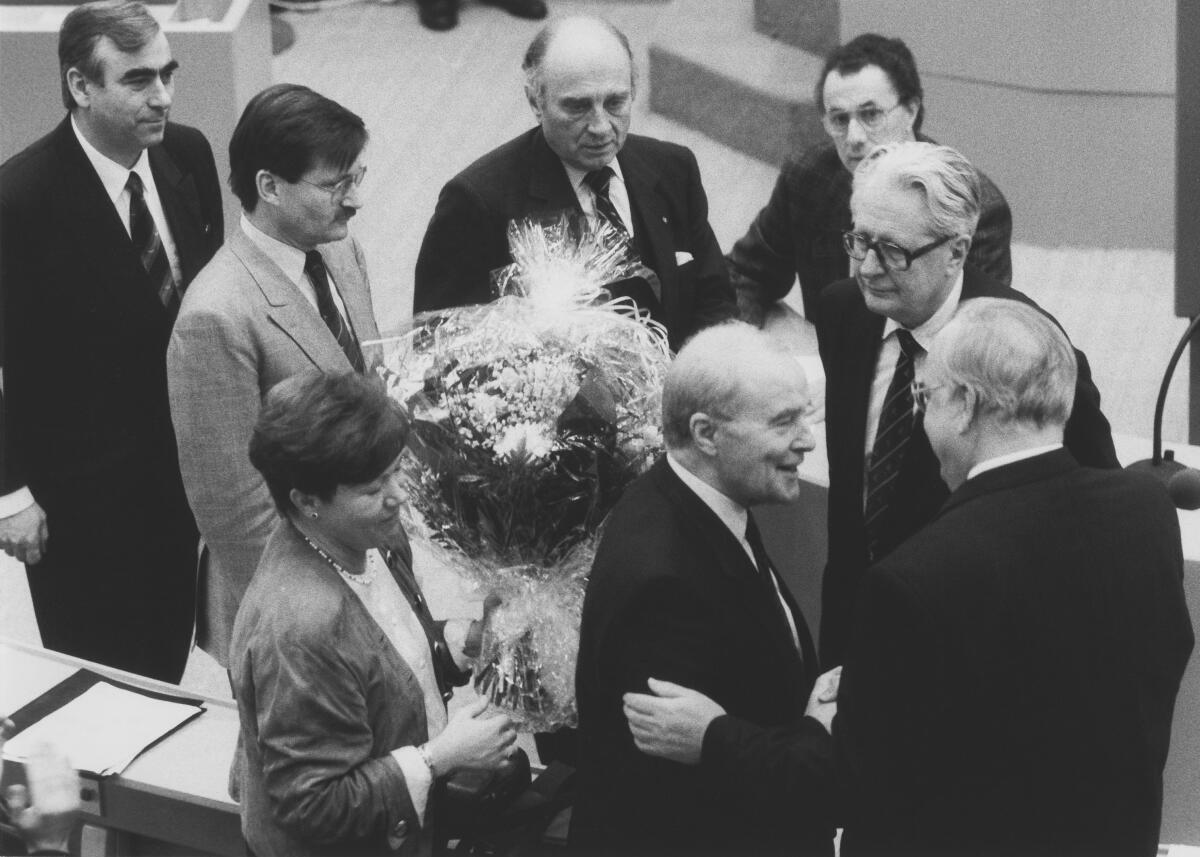 Kohl, Helmut; Dregger, Alfred; Lambsdorff, Otto Graf; Waigel, Theo; Solms, Hermann Otto; Vogel, Hans-Jochen Helmut Kohl, CDU/CSU, gewinnt die Kanzlerwahl am 17. Januar 1991 im Wasserwerk in Bonn, dem vorübergehenden Sitzungsort des Deutschen Bundestages. Alfred Dregger, CDU/CSU, MdB, gratuliert dem wiedergewählten Kanzler Helmut Kohl. Im Hintergrund stehend v.l.n.r.: Theodor Waigel, CDU/CSU; Hermann Otto Solms, FDP; Graf Otto Lambsdorff, FDP; Hans-Jochen Vogel, SPD.; Wahl, Kanzlerwahl, Bundeskanzler, Gratulation, gratulieren