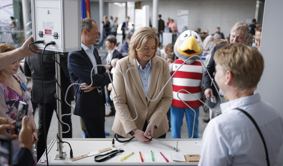 Präsidentin des Deutschen Bundestages, Bärbel Bas, SPD, MdB, spielt das Spiel "Heißer Draht" am Stand des Referates BG 3, Gebäudetechnik beim Tag der Ein- und Ausblicke des Deutschen Bundestages im Paul-Löbe-Haus. Im Hintergrund ist Maskottchen Karlchen Adler zu sehen. Bas, Bärbel Präsidentin des Deutschen Bundestages, Bärbel Bas, SPD, MdB, spielt das Spiel "Heißer Draht" am Stand des Referates BG 3, Gebäudetechnik beim Tag der Ein- und Ausblicke des Deutschen Bundestages im Paul-Löbe-Haus. Im Hintergrund ist Maskottchen Karlchen Adler zu sehen.